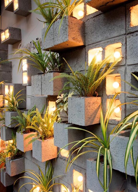 block wall with plants and lights