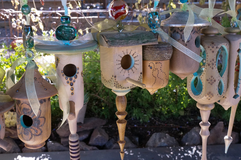 Miniature bird cottages hanging in the garden