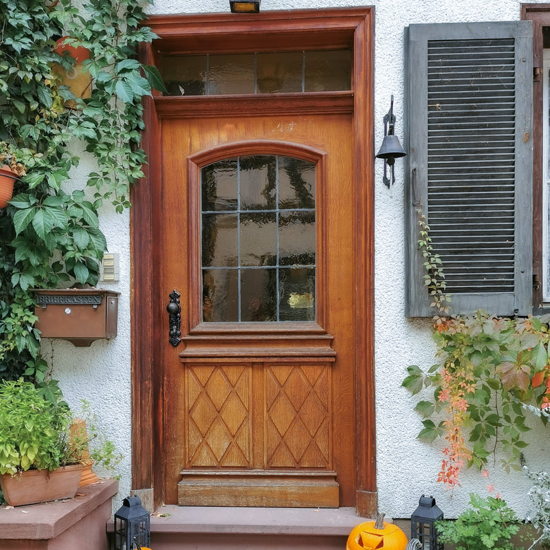 old handmade front door with transom window
