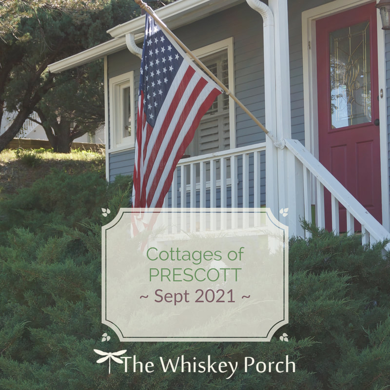 A sweet red white and blue garden cottage with a flag