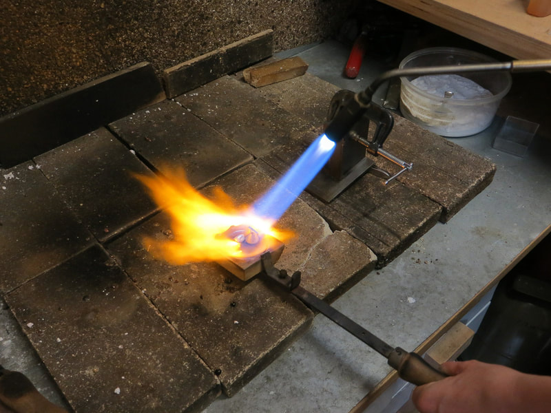 Using a torch to anneal a piece of metal