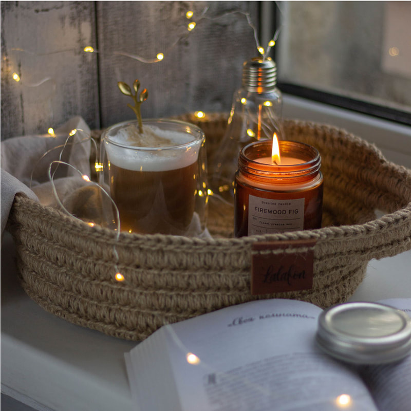 candle, hot tea, and book make for hygge time