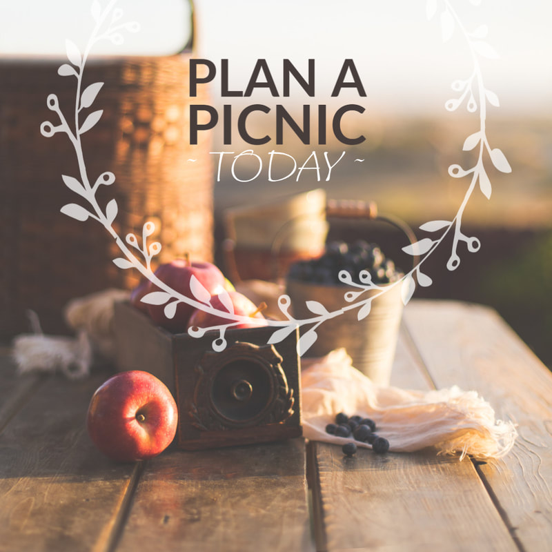A peaceful afternoon with a picnic basket on a table outdoors