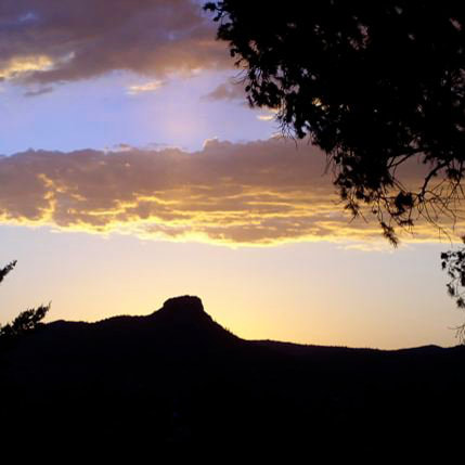 Silouetted view of Thumb Butte during sunset